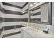 Stylish bathroom with a black and white striped shower and a quartz countertop at 149 Mckinley Dr, Sarasota, FL 34236