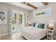 Bright bedroom featuring a king-size bed and French doors leading to a balcony at 149 Mckinley Dr, Sarasota, FL 34236