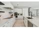 White kitchen with marble island, stainless steel appliances, and herringbone backsplash at 149 Mckinley Dr, Sarasota, FL 34236