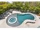 Unique kidney-shaped pool with a spa and swim-up bar at 149 Mckinley Dr, Sarasota, FL 34236