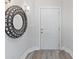 Bright entryway with a large circular mirror and white door at 3702 54Th W Dr # 102, Bradenton, FL 34210