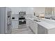 Modern kitchen with white cabinets, stainless steel appliances, and an island at 3702 54Th W Dr # 102, Bradenton, FL 34210