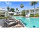 Community pool with lounge chairs and lush landscaping at 3702 54Th W Dr # 102, Bradenton, FL 34210