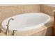 Oval soaking tub with updated fixtures in a relaxing bathroom at 6918 Grand Estuary Trl # 102, Bradenton, FL 34212