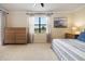 Main bedroom with dresser and golf course view at 6918 Grand Estuary Trl # 102, Bradenton, FL 34212