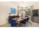 Bright dining room featuring a wood table and blue chairs at 6918 Grand Estuary Trl # 102, Bradenton, FL 34212