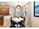 Bright dining room featuring a white table and blue chairs at 6918 Grand Estuary Trl # 102, Bradenton, FL 34212