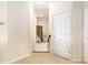 Light-colored hallway with tile floor and access to upper level at 6918 Grand Estuary Trl # 102, Bradenton, FL 34212