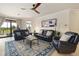 Relaxing living room featuring leather sofas and a ceiling fan at 6918 Grand Estuary Trl # 102, Bradenton, FL 34212