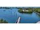 Waterfront view with a wooden dock and boats at 207 Woodland Dr # 207, Osprey, FL 34229