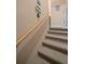 Carpeted staircase with a wooden handrail at 6736 Fairview Ter # 6736, Bradenton, FL 34203