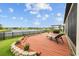 Backyard deck overlooking a lake with lounge chair at 6309 75Th E Ave, Palmetto, FL 34221