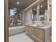 Spa-like bathroom with double vanity and a freestanding bathtub at 1150 Windsong Ln # 200, Sarasota, FL 34242