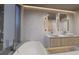 Modern bathroom with double sinks and a soaking tub at 1150 Windsong Ln # 200, Sarasota, FL 34242