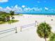 Aerial view of Siesta Beach, featuring volleyball courts and beachgoers at 1150 Windsong Ln # 200, Sarasota, FL 34242