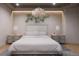 Bright bedroom with large bed, nightstands, and chandelier at 1150 Windsong Ln # 200, Sarasota, FL 34242