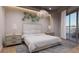 Bright bedroom with large bed, chandelier, and balcony access at 1150 Windsong Ln # 300, Sarasota, FL 34242