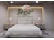 Spacious bedroom with king-size bed and elegant chandelier at 1150 Windsong Ln # 300, Sarasota, FL 34242