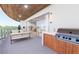 Private balcony with outdoor kitchen and seating area at 1150 Windsong Ln # 400, Sarasota, FL 34242