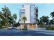 Modern three-story building with attached garage and tropical landscaping at 1150 Windsong Ln # 400, Sarasota, FL 34242