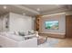 Spacious living room featuring a sectional sofa and large TV at 1150 Windsong Ln # 400, Sarasota, FL 34242