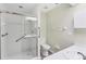 This bathroom includes a walk-in shower with safety bars, a white toilet, and a sink at 318 Chartley N Ct, Sarasota, FL 34232