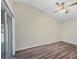 This bedroom features wood-look floors, a sliding glass door, and a ceiling fan at 318 Chartley N Ct, Sarasota, FL 34232