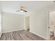 This bedroom features modern floors, a closet, and an en suite bathroom at 318 Chartley N Ct, Sarasota, FL 34232