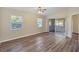 Open living space with wood floors, natural light, and access to the backyard at 318 Chartley N Ct, Sarasota, FL 34232