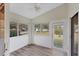 The sunroom features white walls, wood-look floors, and views of the outdoors at 318 Chartley N Ct, Sarasota, FL 34232