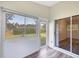 The sunroom features white walls, wood-look floors, and sliding glass doors at 318 Chartley N Ct, Sarasota, FL 34232