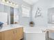 Main bathroom with a corner bathtub and double vanity at 6655 41St Street E Cir, Sarasota, FL 34243