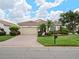 Single-story house with a brick driveway and landscaped lawn at 6655 41St Street E Cir, Sarasota, FL 34243