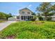 Charming yellow house with a screened porch and a lush front yard at 1810 28Th W St, Bradenton, FL 34205