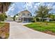 House exterior showcasing a driveway, detached garage, and landscaped yard at 1810 28Th W St, Bradenton, FL 34205