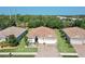 Expansive aerial view of a residential home featuring a tile roof, paver driveway, and lush landscaping at 1934 Mesic Hammock Way, Venice, FL 34292