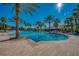 Resort-style community pool surrounded by palm trees and lounge chairs, perfect for relaxation and recreation at 1934 Mesic Hammock Way, Venice, FL 34292