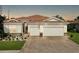 Beautiful home boasting a paver driveway, tile roof, stone accents, and a meticulously landscaped front yard at 1934 Mesic Hammock Way, Venice, FL 34292
