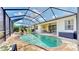Inviting screened-in pool with a spa, complemented by ample patio space and a covered outdoor seating area at 1934 Mesic Hammock Way, Venice, FL 34292