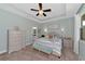 Main bedroom with light gray dresser, neutral bedding, and ceiling fan at 11569 11Th E Ave, Bradenton, FL 34212