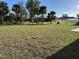Large grassy backyard with mature trees at 2738 N Chamberlain Blvd, North Port, FL 34286