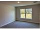 Spacious bedroom with large window and gray carpeting at 2738 N Chamberlain Blvd, North Port, FL 34286