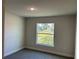 Well-lit bedroom featuring carpet and a window at 2738 N Chamberlain Blvd, North Port, FL 34286