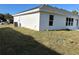 View of the house's side and backyard at 2738 N Chamberlain Blvd, North Port, FL 34286