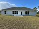 Back of house with grassy backyard at 2738 N Chamberlain Blvd, North Port, FL 34286