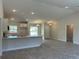 Open concept kitchen with island, white cabinets and gray flooring at 2738 N Chamberlain Blvd, North Port, FL 34286