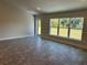 Bright and airy living room with large windows and gray tile flooring at 2738 N Chamberlain Blvd, North Port, FL 34286
