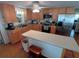 Well-equipped kitchen featuring an island and wood cabinets at 4906 Sea Island Ave, Sarasota, FL 34234