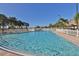 Community swimming pool with lounge chairs and tiki hut at 4906 Sea Island Ave, Sarasota, FL 34234