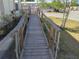 Wooden ramp with handrails providing accessibility to the home at 4906 Sea Island Ave, Sarasota, FL 34234